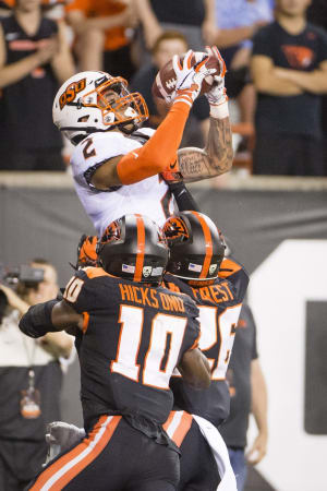 Aug 30, 2019; Corvallis, OR, USA; Oklahoma State Cowboys wide receiver Tylan Wallace (2) catches a touchdown pass against Oregon State Beavers defensive back Jojo Forest (26) during the first half at Reser Stadium. Mandatory Credit: Troy Wayrynen-USA TODAY Sports